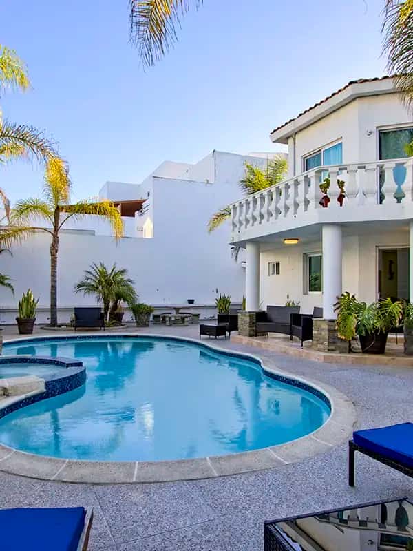 twilight pool lounge chairs palm trees
