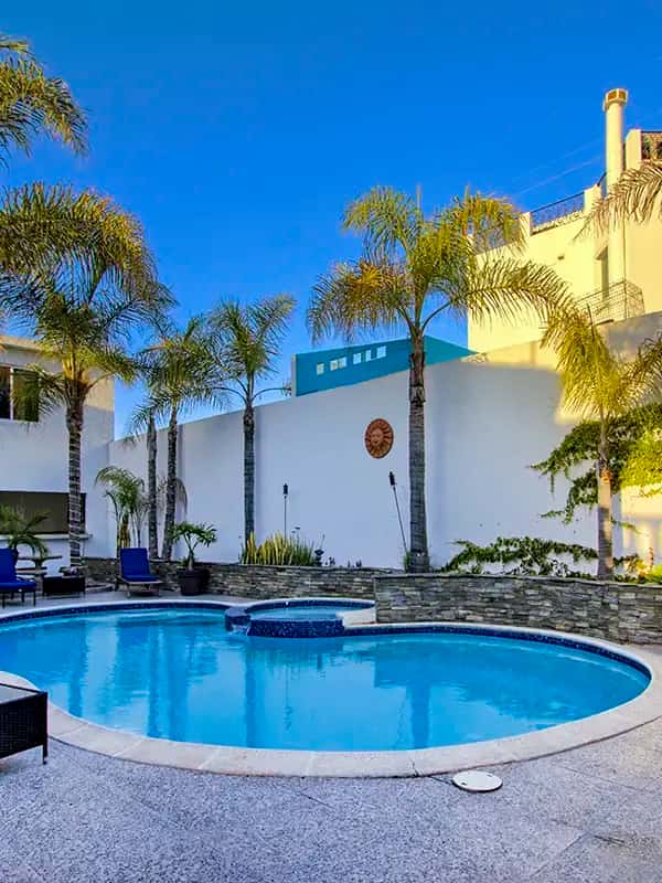 twilight pool palm trees white house background