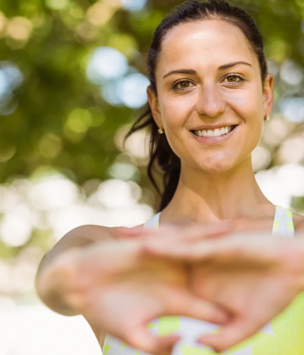 twilight environment woman green tank top smiles camera enviroment