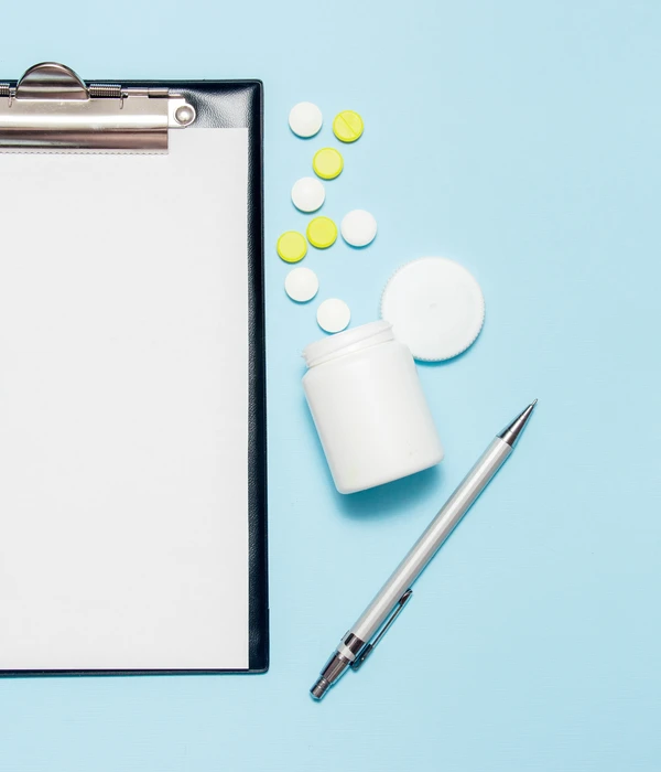 twilight prescription drug clipboard pills pen blue background eow