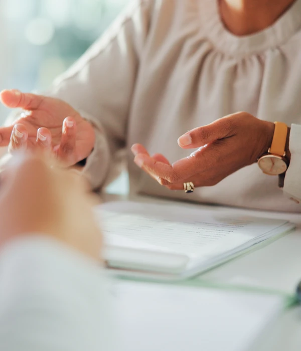 twilight therapy woman sitting table hands clasped paper