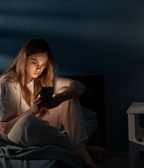 twilight woman sitting bed using cell sex porn addiction